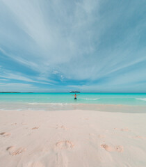 Man enjoing lounging on the ocean at Half moon cay Bahamas private island Caribbean
