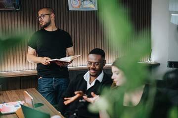 A focused group of diverse colleagues engages in a business discussion in a well-lit, contemporary office space, showcasing teamwork and corporate communication.