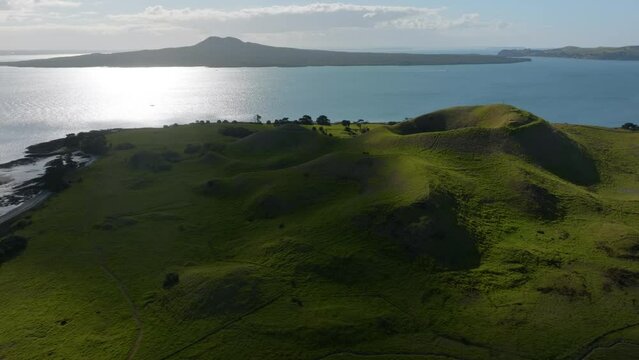 Aerial: Browns Island and the Waitamata harbour. Rangitoto Island is in the background, Auckland, New Zealand.