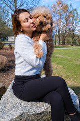Young woman with cute doodle dog