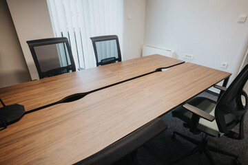 Contemporary business boardroom featuring an elegant wooden table, ergonomic chairs, and a serene...