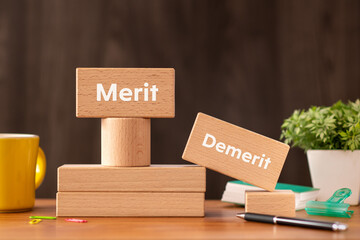 There is wood block with the word Merit or Demerit. It is as an eye-catching image.