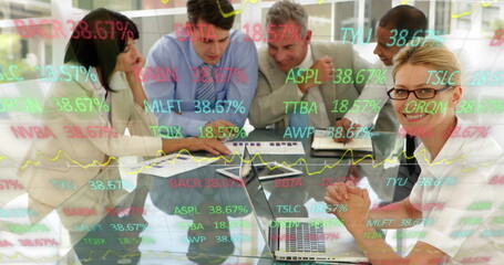 Image of trading board over diverse coworkers discussing reports in meeting at office - Powered by Adobe