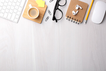 Flat lay composition with different office stationery on white wooden table, space for text