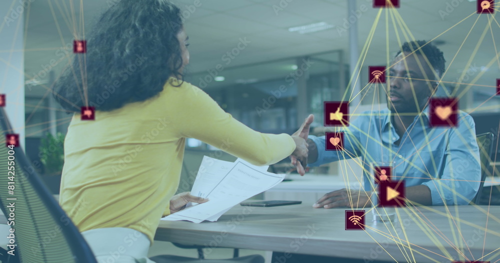 Sticker Image of connected icons forming globes over diverse coworkers discussing and shaking hands