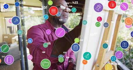 Image of social media icons over african american man painting