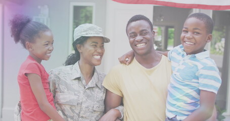 Image of lights over happy african american soldier mother hugging kids and husband