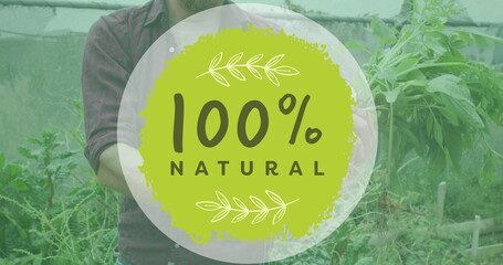 Image of 100 percent natural text over caucasian man gardening