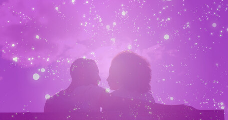 Image of light spots over biracial couple embracing