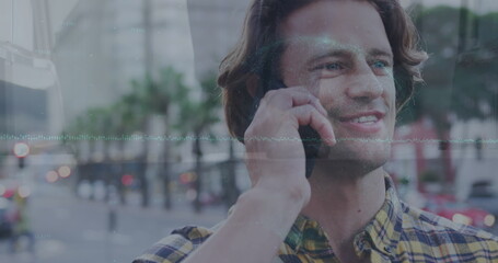 Image of graph, globe, low section of businessman on smiling caucasian man talking on cellphone