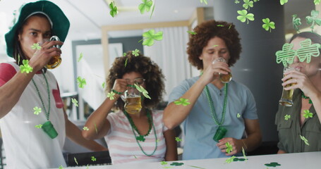 Image of clover icons over diverse friends drinking beer © vectorfusionart