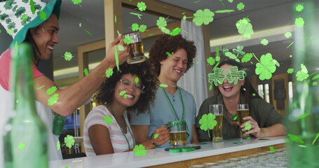 Image of clover icons over diverse friends drinking beer © vectorfusionart