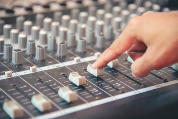 Production sound engineer hands working on recording studio mixing voice control. Expert adjusting...