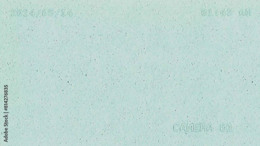 Poster camera footage showing a textured background with dust and noise particles