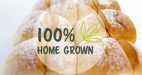 Image of 100 percent home grown text banner against close up of fresh bread on white background - Powered by Adobe