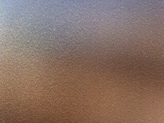 A detailed closeup of a brown painted steel surface, highlighting its smooth texture and subtle variations in tone, showcasing the craftsmanship and durability of the material.