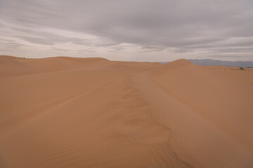 Dramatic sky over the never-ending sand dunes of Gobi desert in Inner Mongolia