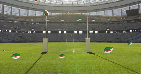 Image of rugby balls with flag of wales over stadium