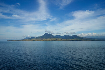 View of the mountain in the middle of sea. Mountain view on beautiful island in Indonesia.