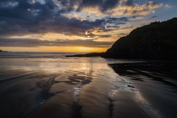 Wild surf at sunset  in Anawhata on the west coast of Auckland, New Zealand.