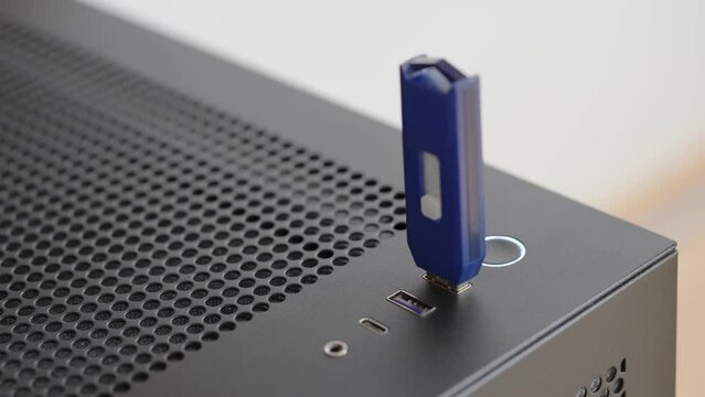 Man plugging and unplugging a USB flash drive. PC. Data storage. Close up