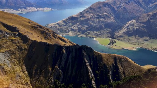 Colourful natural landscape of high mountains and Lake Wanaka from Isthmus Peak. Beautiful sunny day.