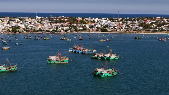 Commercial Fishing Boats (Fleets) Floating Over The White Sand Peninsula Of Vietnam's Historic Fishing Village; Aerial Parallax Over The South China Sea, Southeast Asia.