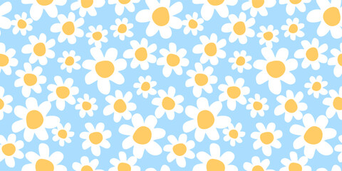 Seamless pattern with chamomile flowers on blue background. 1970s trippy daisy pattern. Design for textile, wrapping paper, wallpaper.