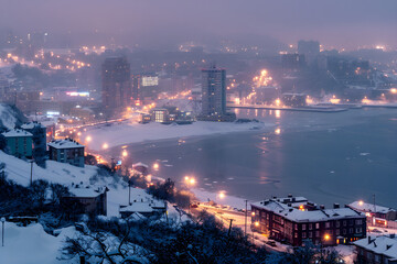 Winter's Embrace: A Snow-Blanketed Vladivostok City Under Dusky Sky 
