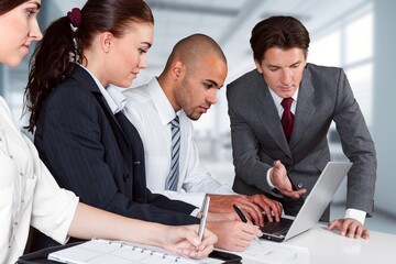 Group of  businesspeople standing with papers in office together