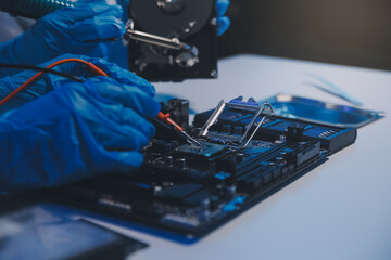 Naklejka premium Close up of Technician measuring voltage electronic circuit board television, Service after sale fix electric equipment within insurance.