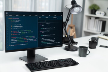 Programming code on computer screen desktop placing on working desk showing intelligent website...