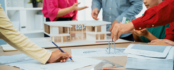 Professional architect team select sustainable house materials while skilled engineer using divider...