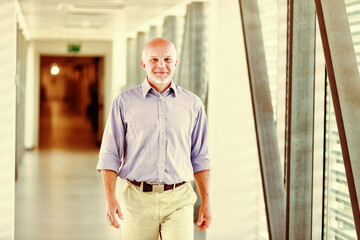 Man in blue shirt walks through corridor