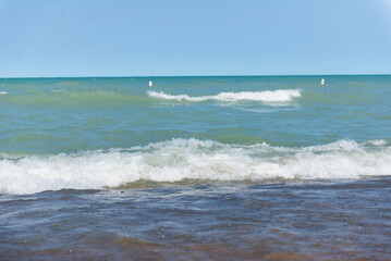 Beach near Lake Michigan. Rough waves. Two waves on the water.