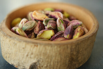 Wooden bowl filled with pistachios, a natural and nutritious superfood