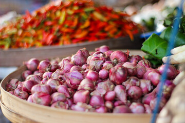 a container full of shallots sold in traditional markets