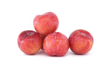 Four crimson plums isolated on white background