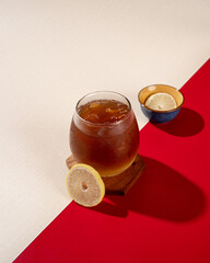 ced lemon tea is a tea drink served cold with ice cubes and lemon.