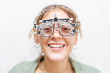 Portrait of a happy woman wearing optometrist test frame