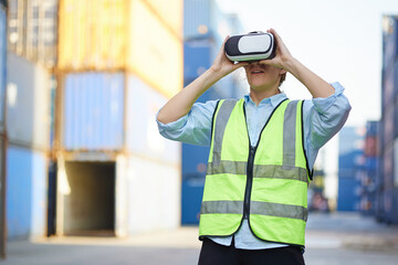 worker or engineer wearing virtual reality glasses(VR) in containers warehouse storage