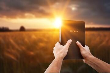 Christian hand holding holy Bible book