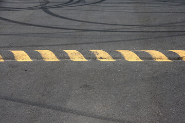 Speed bump and skid marks on asphalt