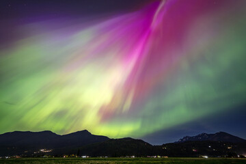 Northern lights vibrant colors over a mountain range
