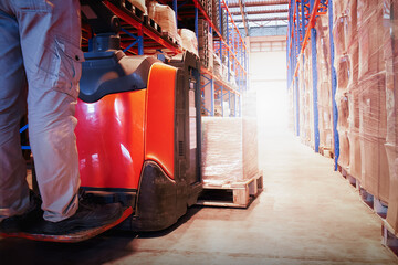 Warehouse Workers Loading a Package Boxes Pallets at Warehouse. Electric Forklift Loader....