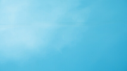 Blue water background with sunshine. Close-up surface of blue gradient texture in a swimming pool....