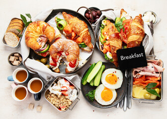 Large selection of breakfast food on a table.