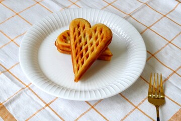 Heart shape of Plain Croissant Waffle or Croffle served in white plate