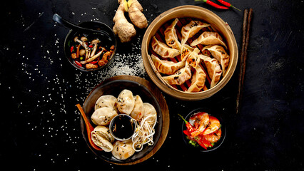 Chinese dumplings, soy sauce, mushrooms on dark background. traditional asian food concept