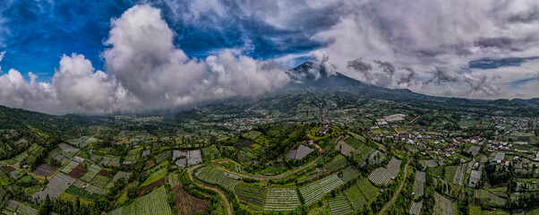 Nature's Canvas: Panoramic View of Vibrant Village Nestled in a Mountain Valley 